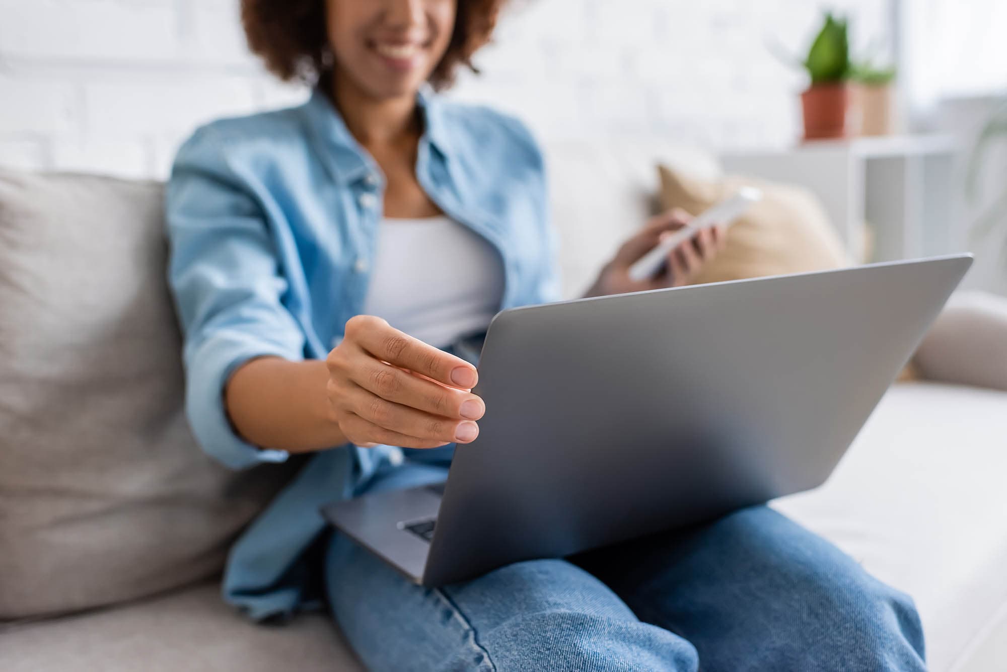 young-african-american-lady-looking-at-her-laptop
